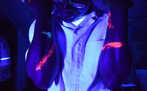 simulated pathogens glowing on arms