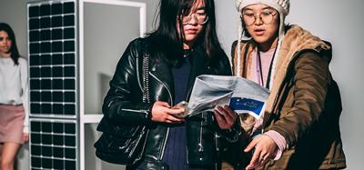 Students looking at a booklet