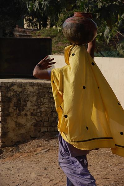 Abheypur resident carrying water back to her home