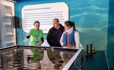 Technical staff talking to visitors