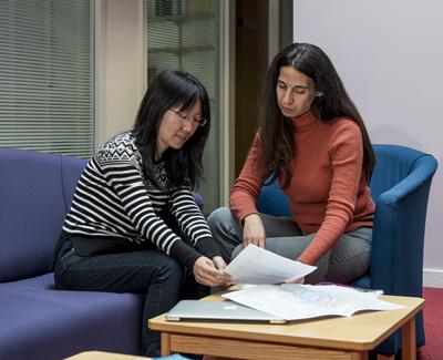 Learning support assistant and student at a table
