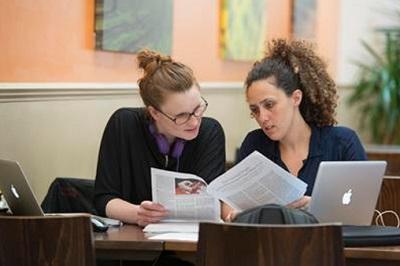 Students reading through paperwork
