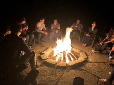Students round campfire