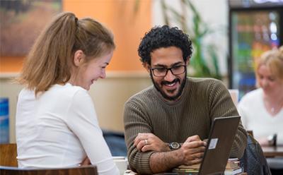 Two students with a laptop