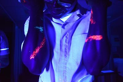 Simulated pathogens glowing on arms