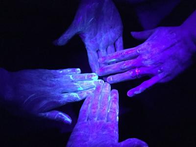 UV germ training lotion on hands