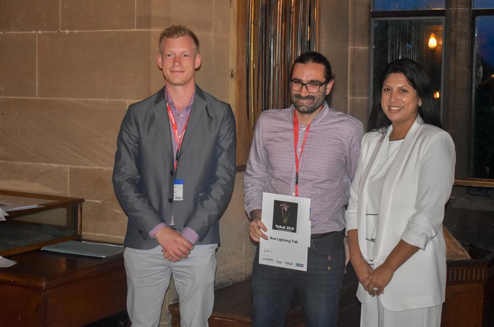 Orestis receiving his award from Symposium's Chair Dr Farah Ahmed
