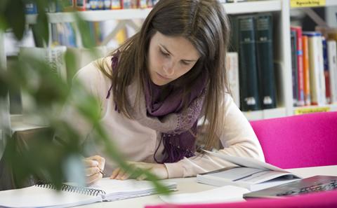 Student writing in a notebook