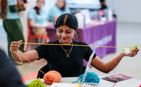 Woman sewing with a ball of yarn