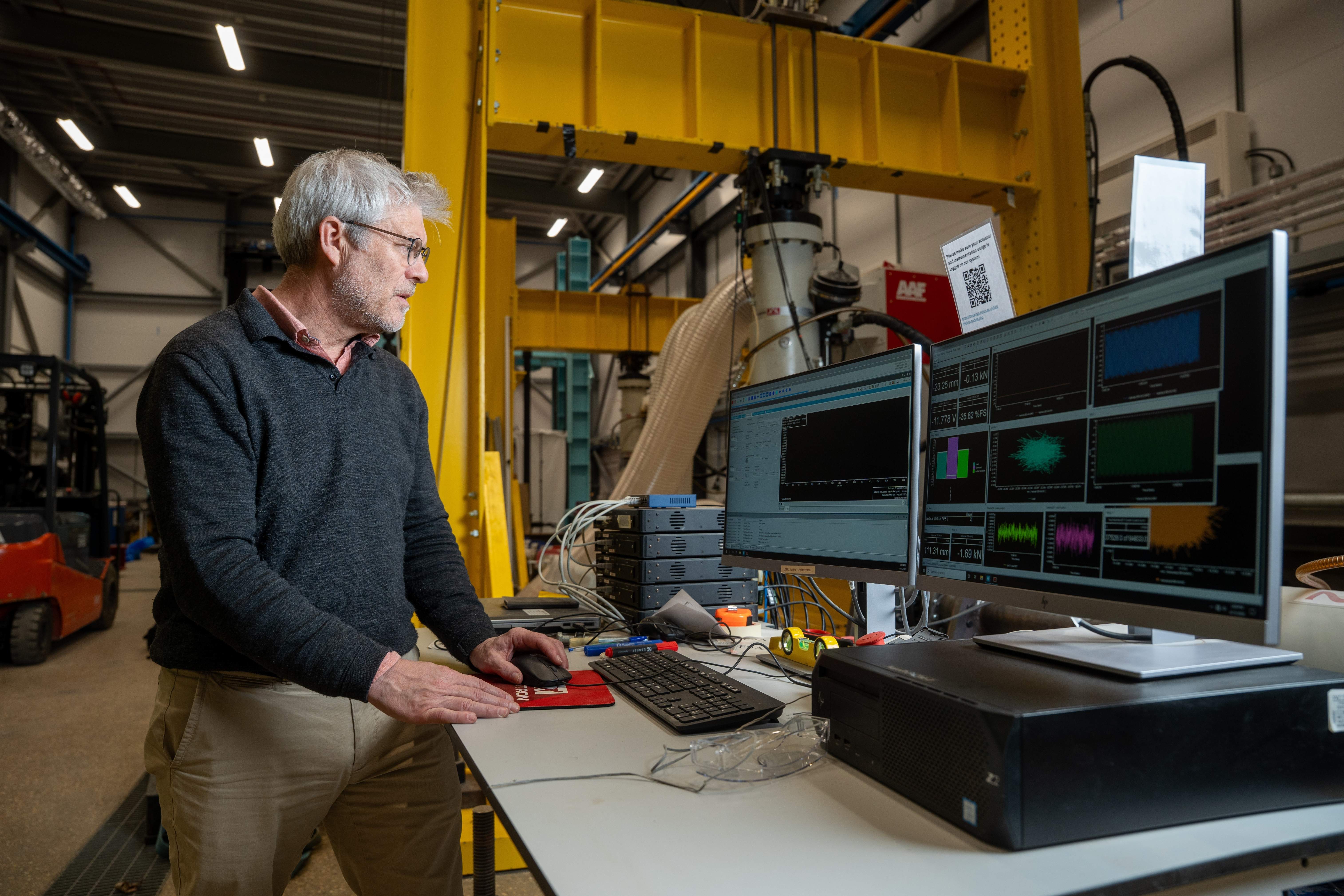 Professor David Richards reviewing experimental data at a laboratory workstation.