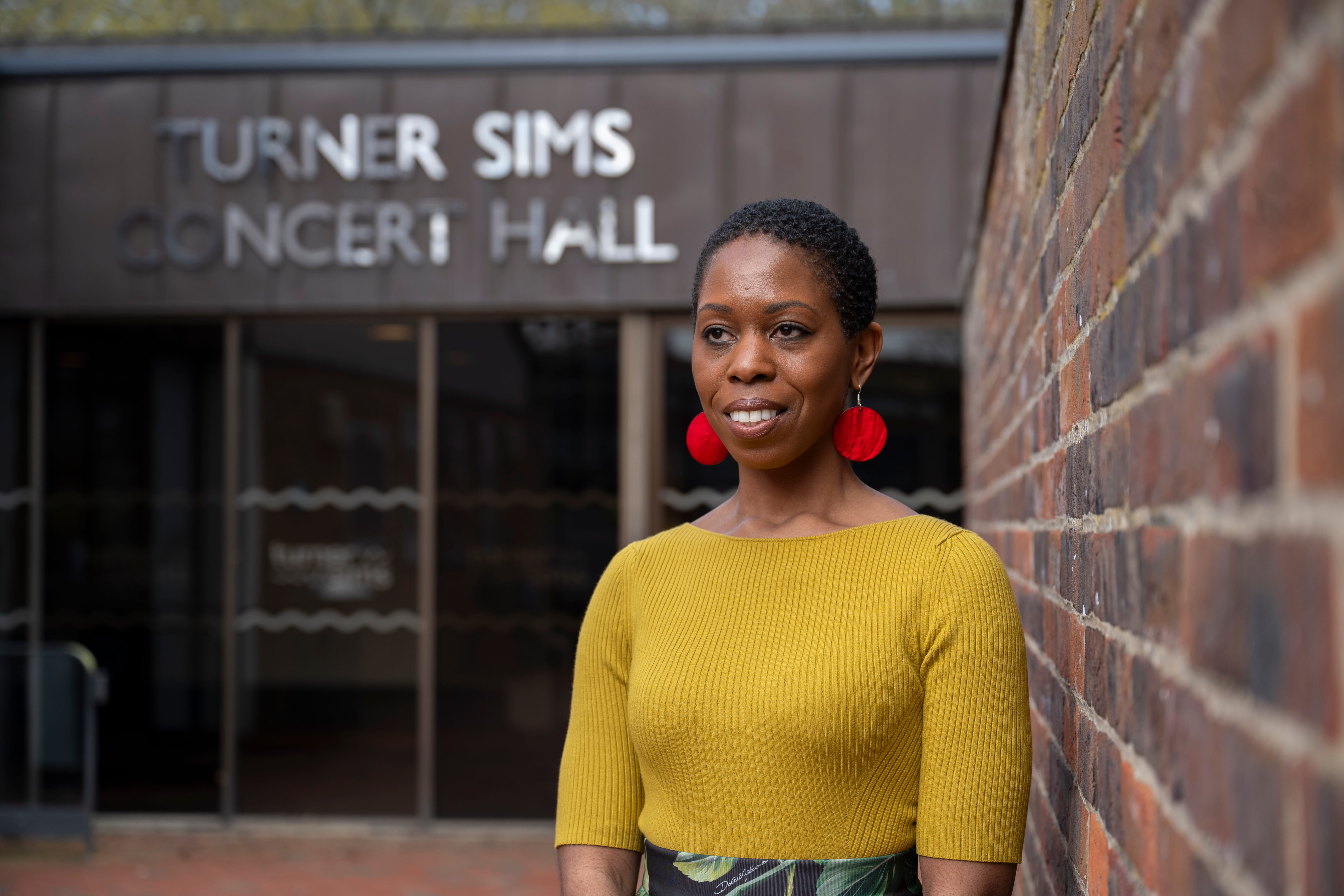 Dr Samantha Ege standing outside Turner Sims Concert Hall at the University of Southampton.