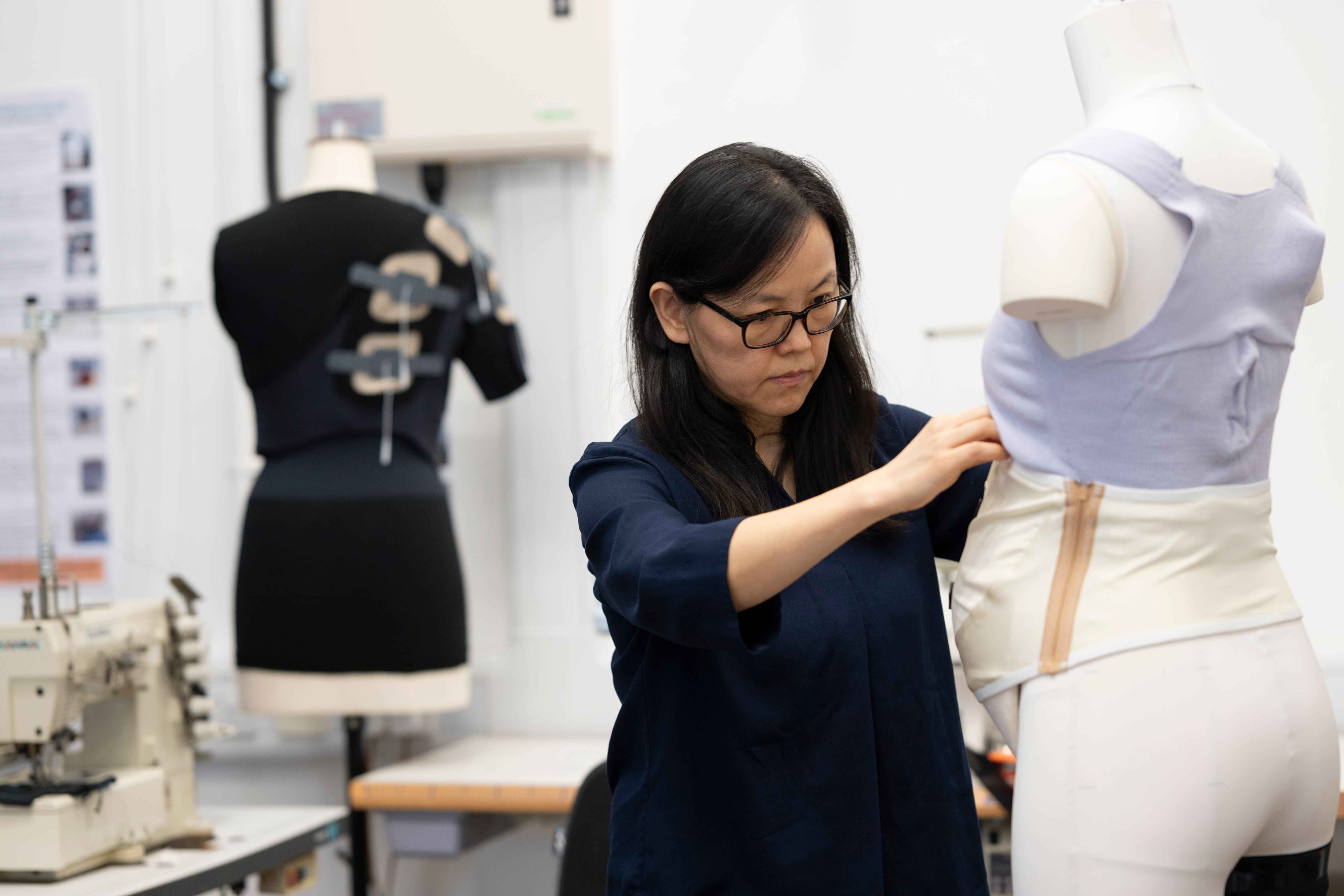 Professor Kai Yang, Professor of E-textiles in Healthcare at the University of Southampton, works on a prototype wearable garment in her research laboratory.