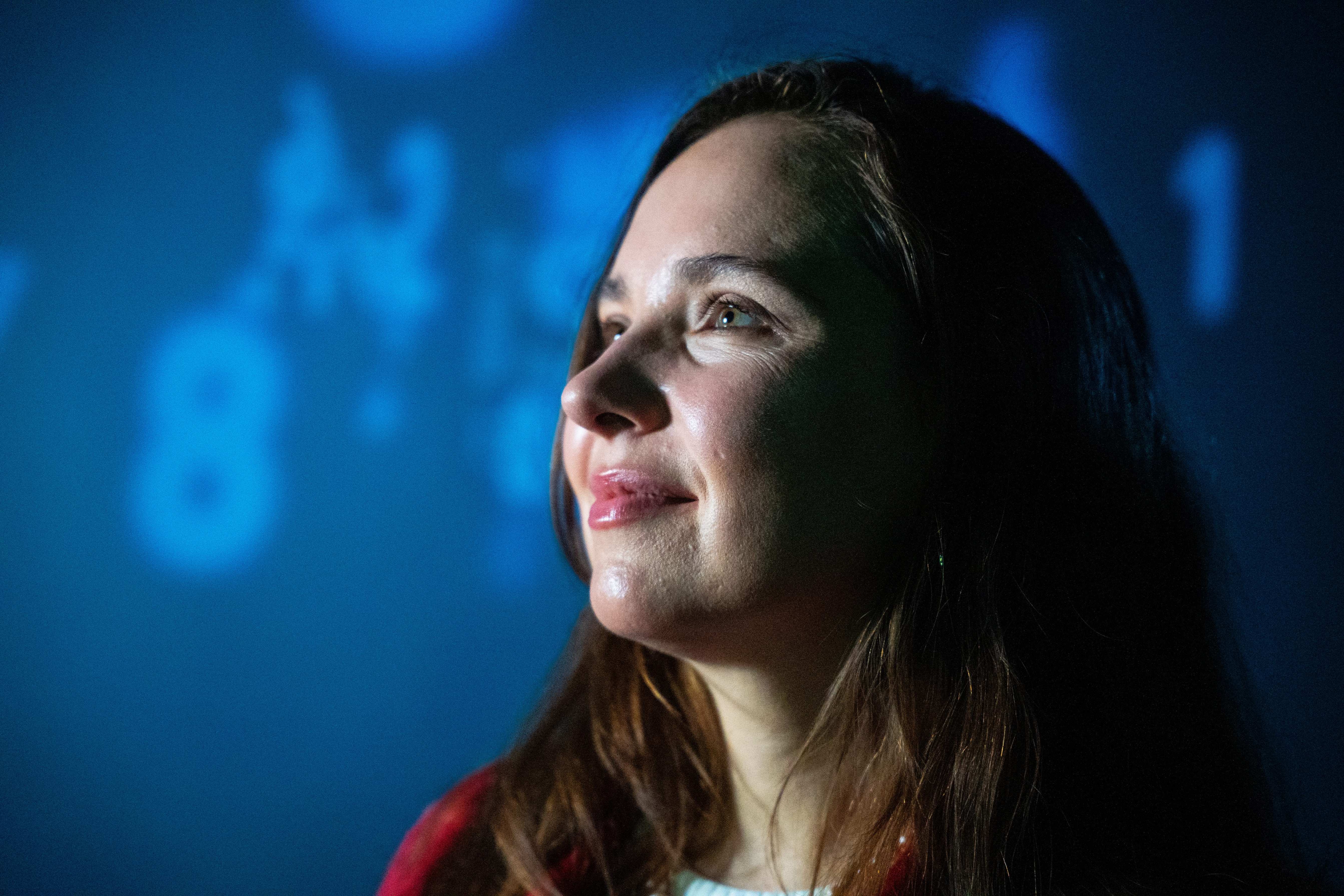 Dr Larisa Yarovaya looking towards a projected digital display.