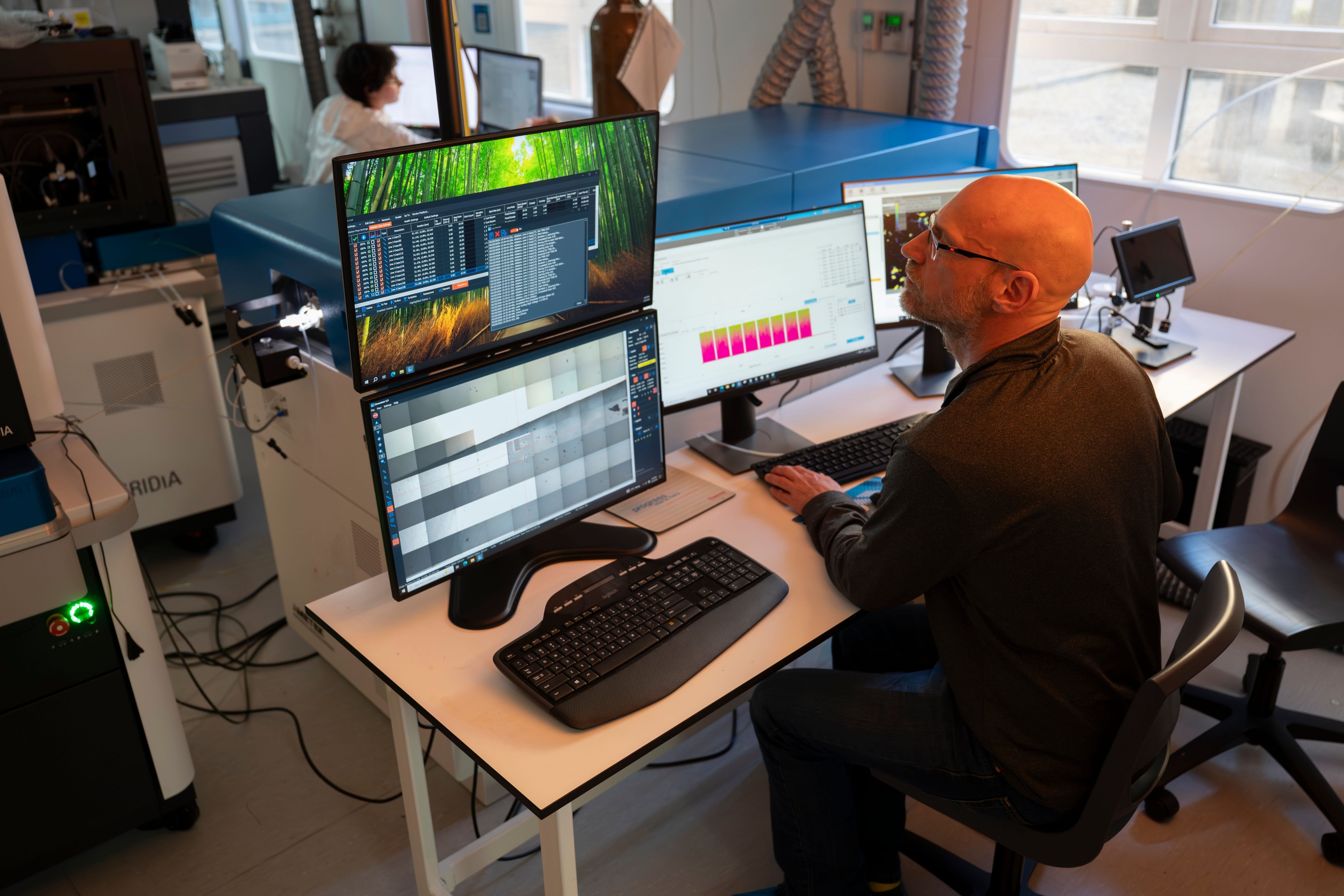 Mark Moore analyses research data at a computer workstation in a laboratory.