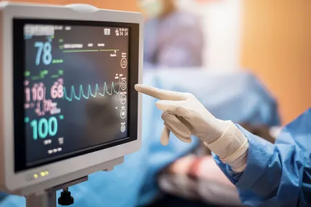 A surgeon monitoring a screen.