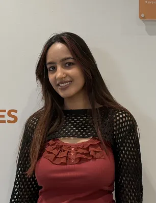 BA History graduate Siya, is smiling at the camera.
