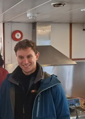MSc Geophysics student smiling at the camera.