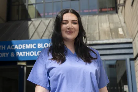 Medical student Becca standing outside University Hospital Southampton.