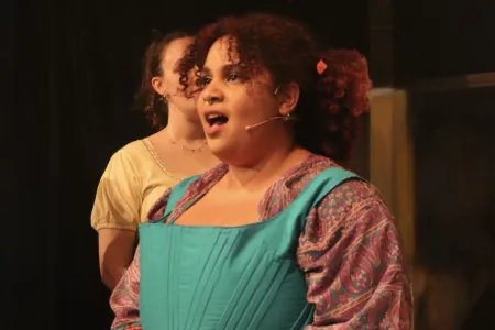 BA English student performing Shakespear on a stage.