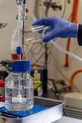 A laboratory experiment transferring liquid into a reaction vessel.
