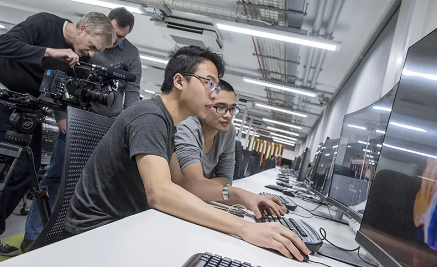 Two students working at a computer in the David Barron computing lab.