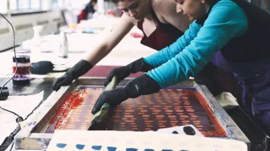 Two students working on printed textiles.