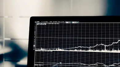 A laptop displaying a graph.