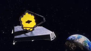 James Web telescope in space with earth on the bottom right.