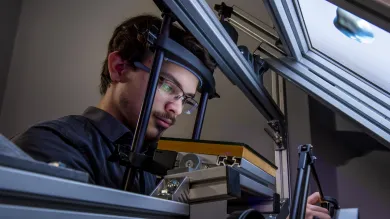 A research student uses equipment in the visual haptic lab