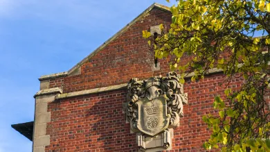An old stone version of the University of Southampton coat of arms, affixed to the side of Hartley Library.