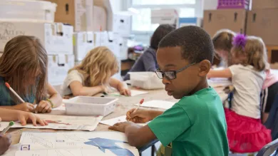 young children drawing and writing and school