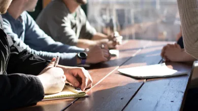 People round a table in a meeting
