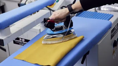 A hand using an ironing press