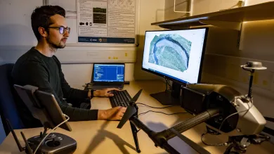 One researcher analysing geospatial data with a computer