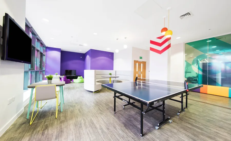 Orion Point common room including TV's, seating and a table tennis table