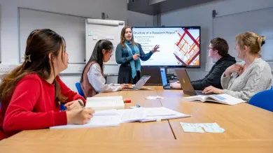 Students of different ages and ethnicities preparing for a research proposal