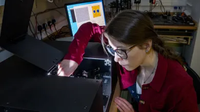 A woman checking fibre refractive index profiling