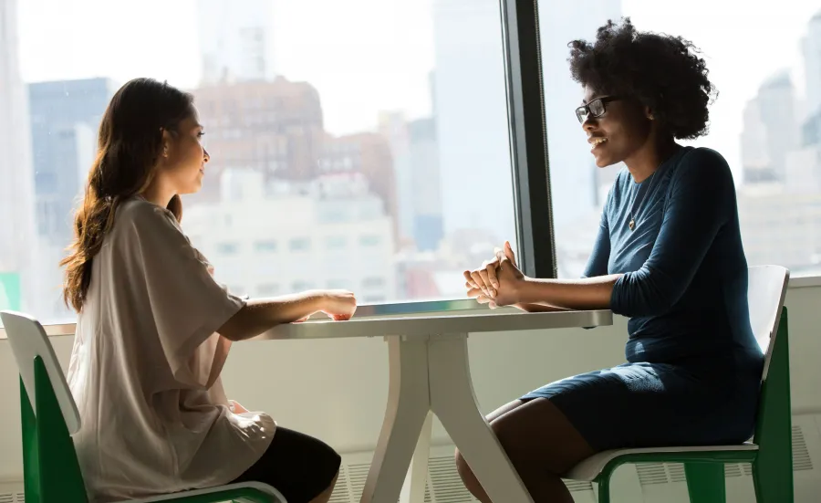 Two women talking at a table