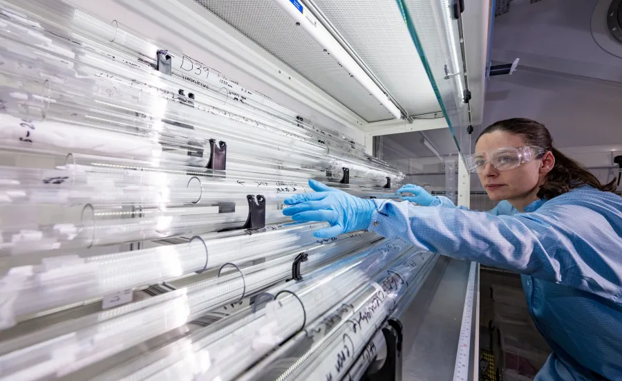 A woman standing near the preform tube store