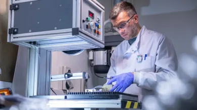 Scientist carrying out experiment using the facilities equipment