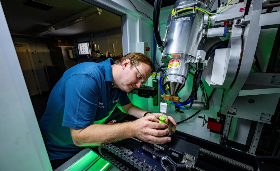 A scientist prepares a specimen to have its x-ray taken.
