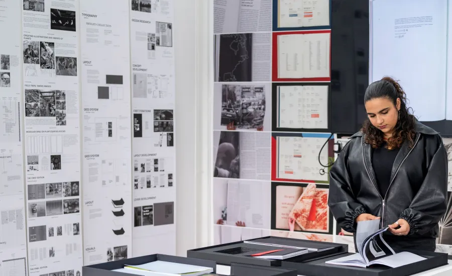 BA Graphic Communication student looking at artwork