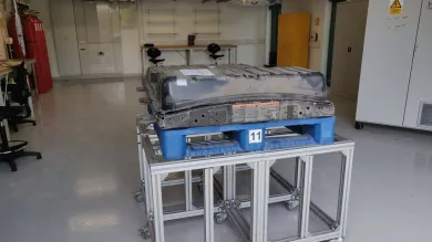 Electric car battery cell on a table in a clean and tidy workshop 