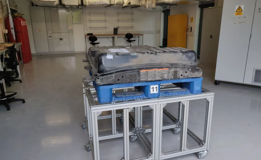 Electric car battery cell on a table in a clean and tidy workshop 
