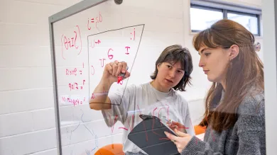 Two students filling in a vowel space with symbols from the International Phonetic Alphabet’