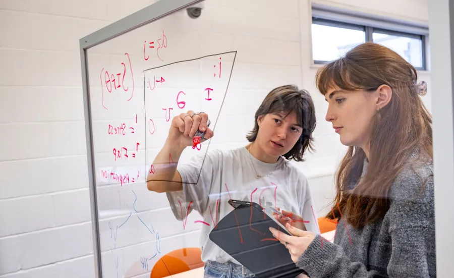 Two students filling in a vowel space with symbols from the International Phonetic Alphabet’