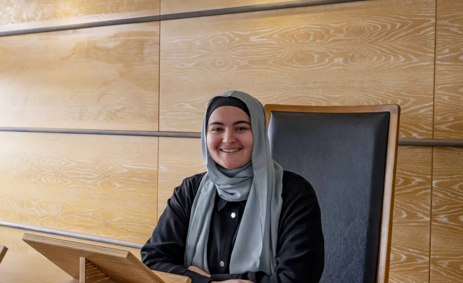 Nora Belkhiter, Law student, sits at the moot court bench in Southampton Law School..