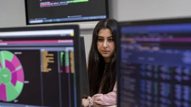 A student working at a computer in the Financial laboratory