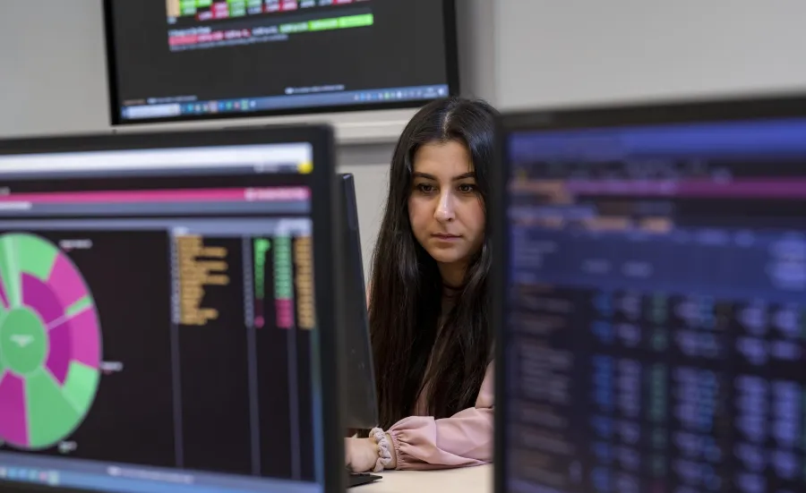 A student working at a computer in the Financial laboratory
