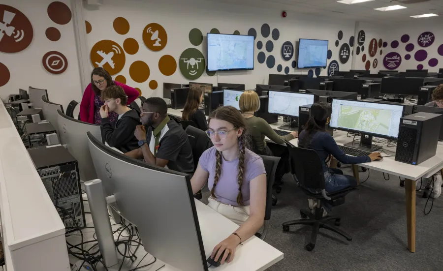A computer lab with students working on desktop computers